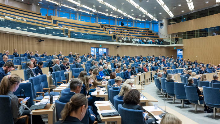Members of the Riksdag sitting in the Chamber and visitors in the public gallery.