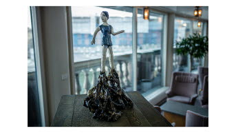 Sculpture, girl in a blue dress.