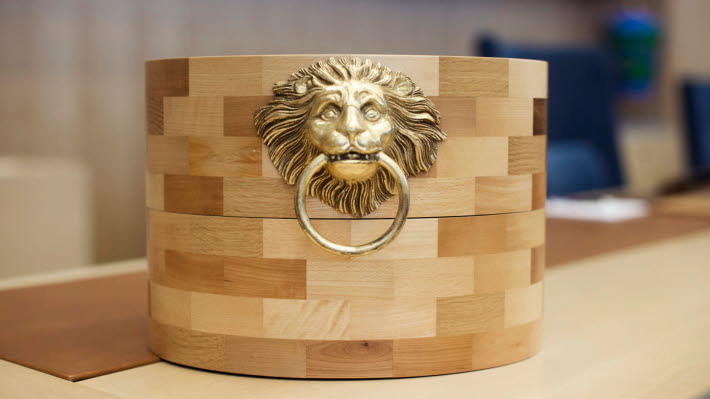 The voting casket which stands on the Speaker's platform. The box is made of 15 different types of wood.