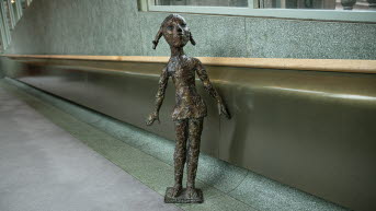 Sculpture, girl with pigtails.